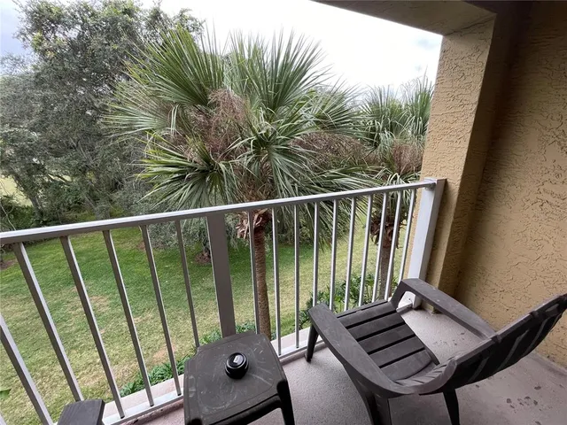 a view of a balcony with wooden floor