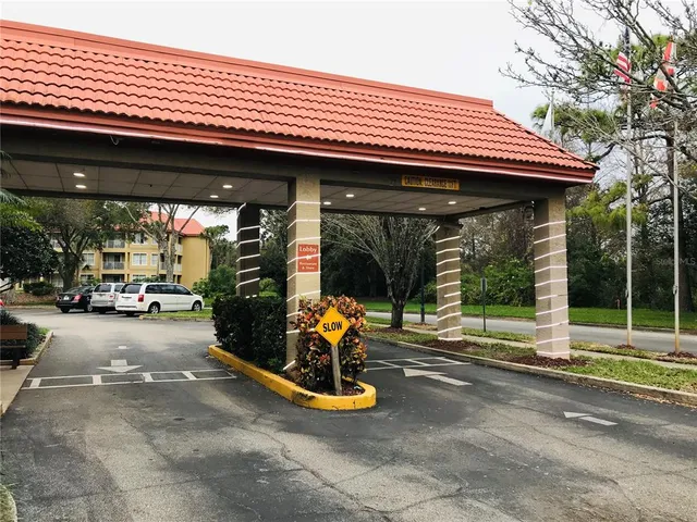 a view of a patio with a table and chairs under an umbrella with a patio