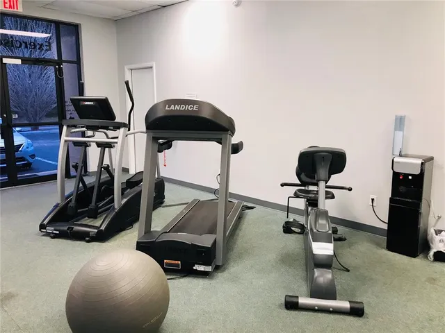 a room with gym equipment and a flat screen tv