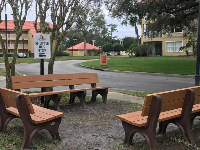 a view of a chairs and table in backyard of the house
