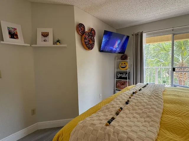 a bed sitting in a bedroom next to a window