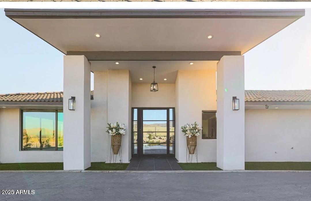 a view of a hallway with wooden floor and windows