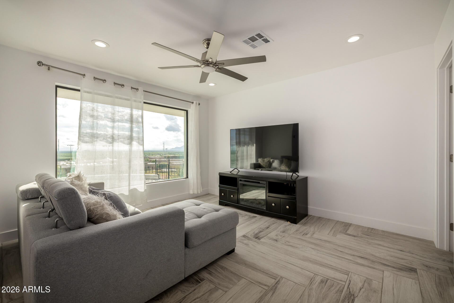 2809 East Frye Road Phoenix, AZ 85048 - Photo 27 of 47 a living room with furniture and a flat screen tv
