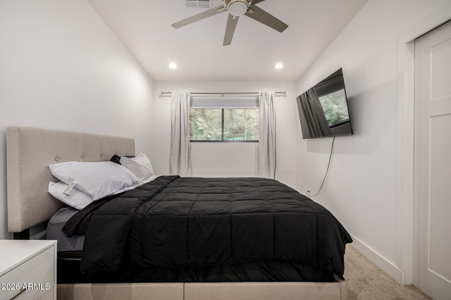 2809 East Frye Road Phoenix, AZ 85048 - Photo 41 of 47 a bedroom with a bed and a flat tv screen