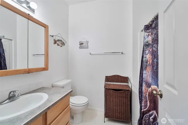 a bathroom with a toilet sink and mirror