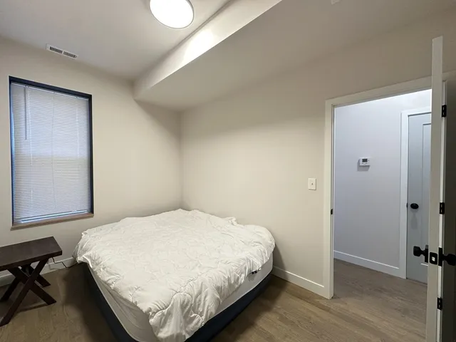 a bedroom with a bed and a window