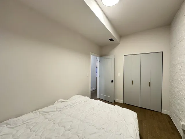 a bedroom with a bed and a bathroom