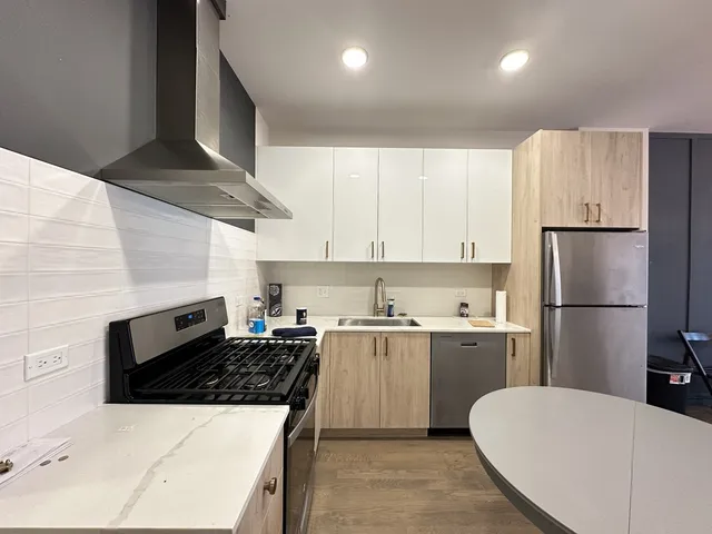 a kitchen with a stove a refrigerator and a sink