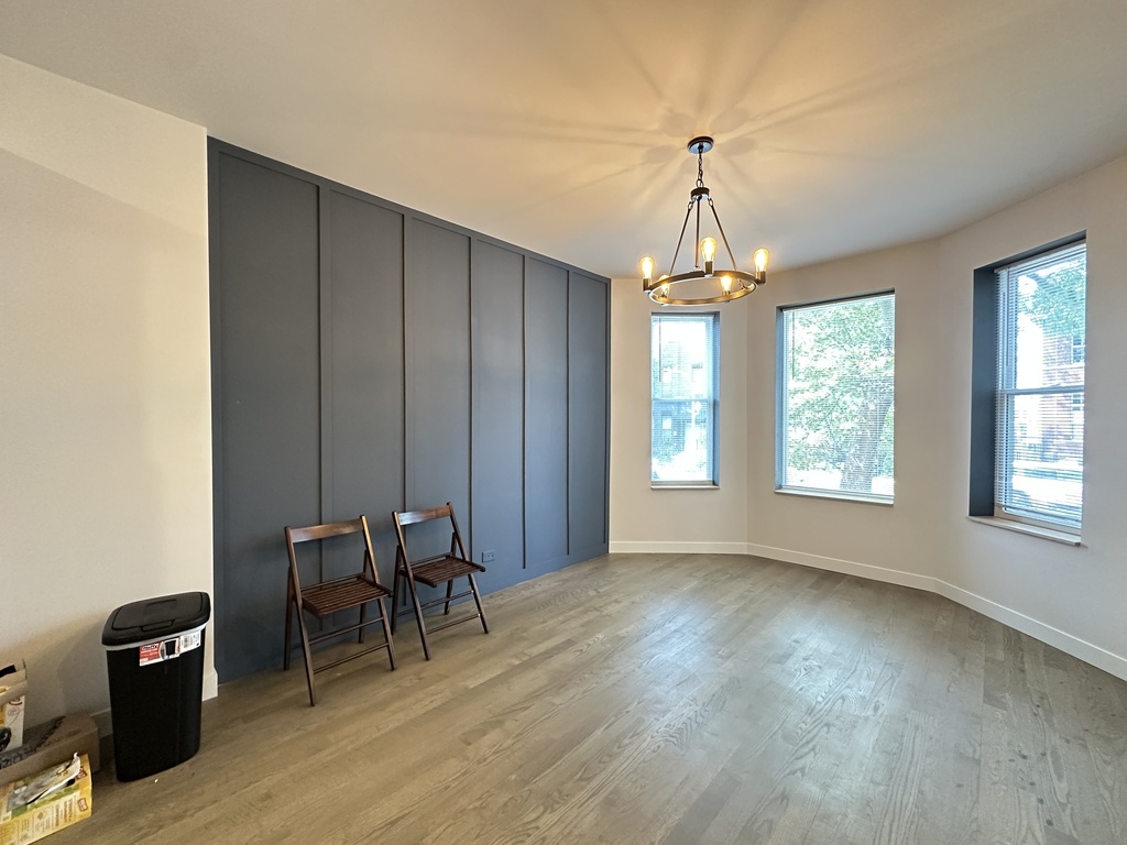841 North Mozart Street, Unit 3F Chicago, IL 60622 - Photo 8 of 20 a view of a livingroom with furniture window and wooden floor