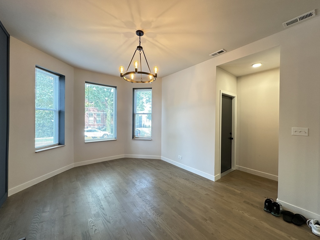 841 North Mozart Street, Unit 3F Chicago, IL 60622 - Photo 9 of 20 a view of a livingroom with wooden floor and a window