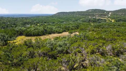 a view of a mountain in the distance in a field