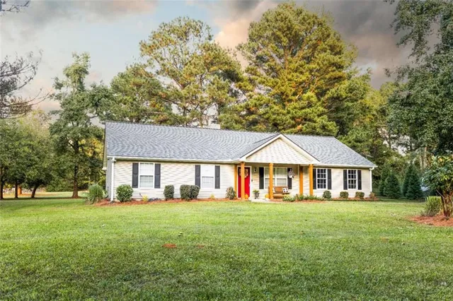 a front view of house with yard and green space