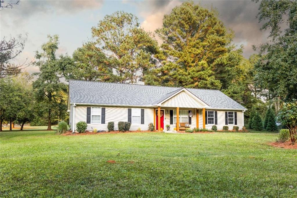 935 Snip Dillard Road Northwest Monroe, GA 30656 - Photo 1 of 1 a front view of house with yard and green space