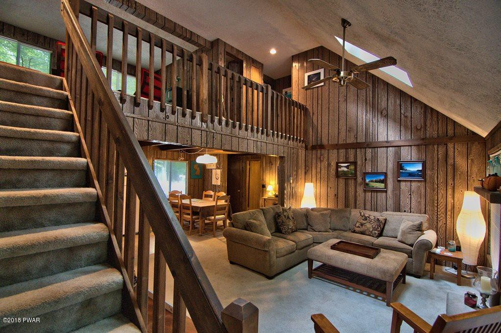 3278 Northgate Road Lake Ariel, PA 18436 - Photo 25 of 40 a living room with furniture or stairs and a chandelier