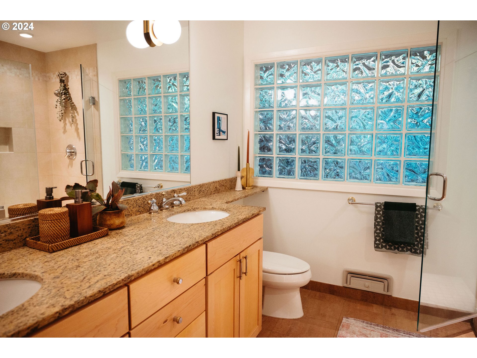 811 Northwest Skyline Crest Road Portland, OR 97229 - Photo 16 of 45 a bathroom with a granite countertop sink a toilet a mirror and shower