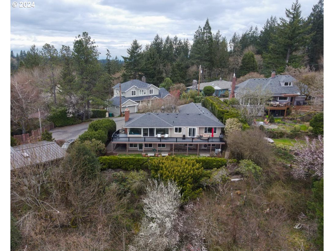 811 Northwest Skyline Crest Road Portland, OR 97229 - Photo 29 of 45 a view of a big house with a big yard plants and large trees