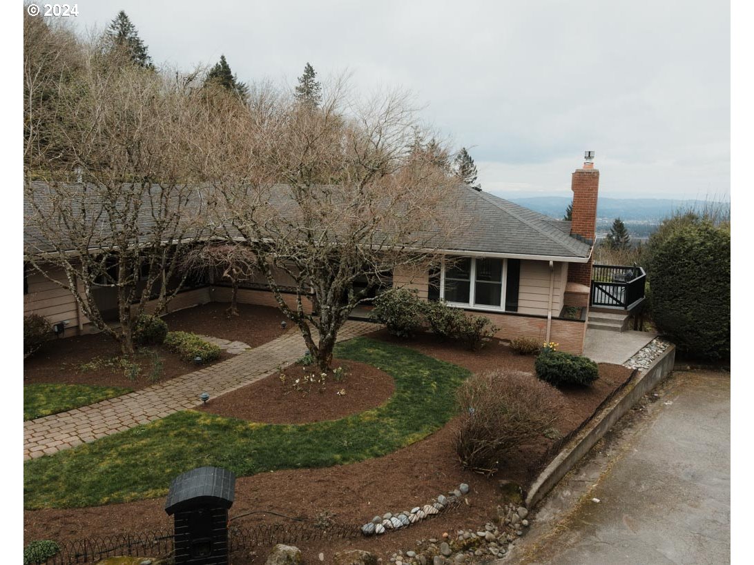 811 Northwest Skyline Crest Road Portland, OR 97229 - Photo 37 of 45 a front view of a house with a garden