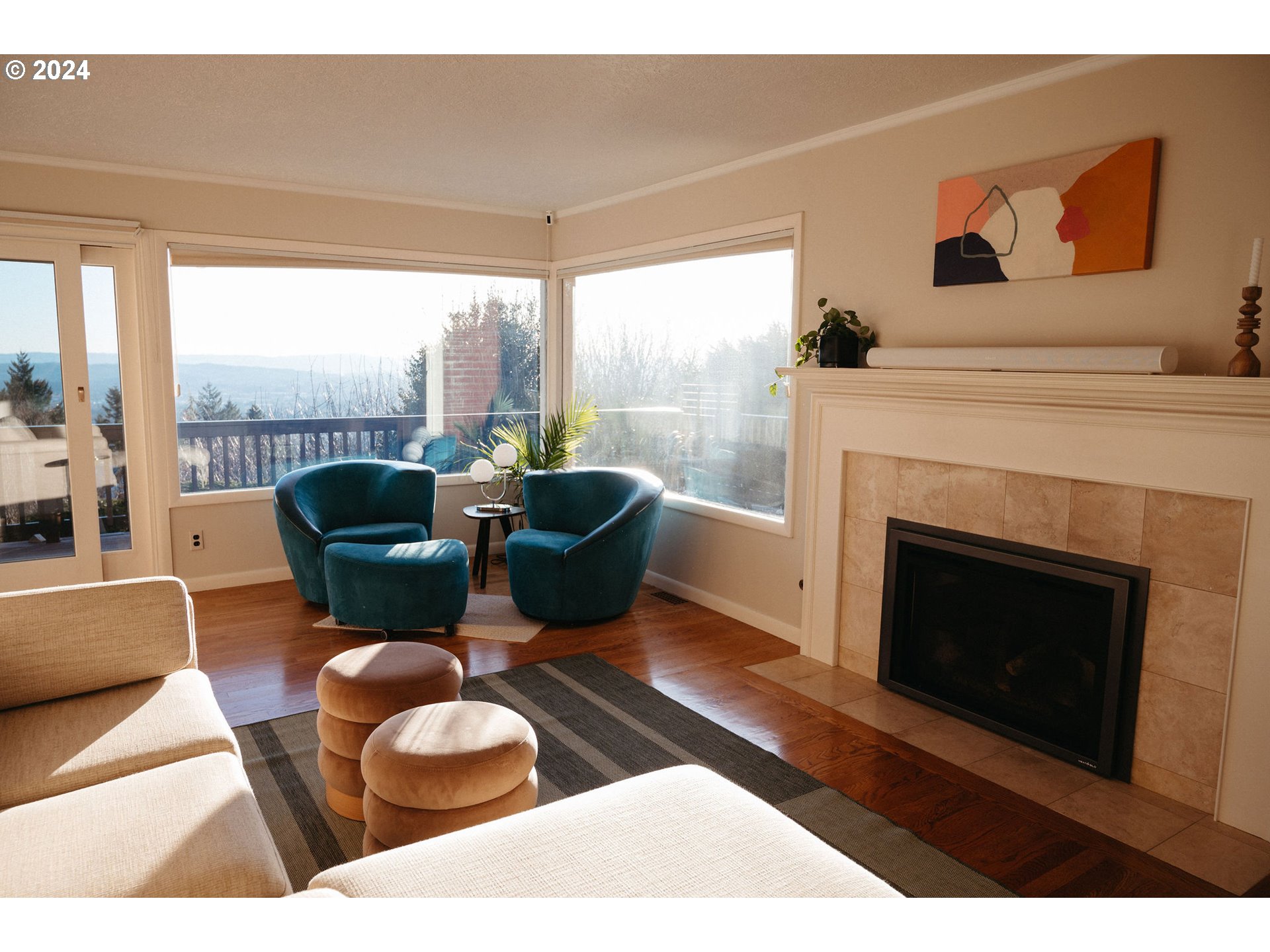 811 Northwest Skyline Crest Road Portland, OR 97229 - Photo 5 of 45 a living room with furniture a fireplace and large windows