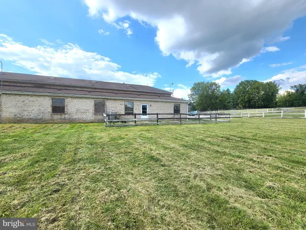 a view of a house with a big yard and a large tree