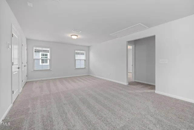 an empty room with a empty space and windows