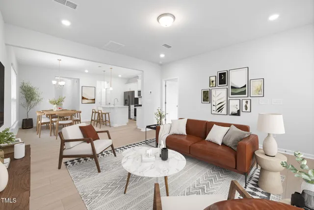 a living room with furniture a flat screen tv and a large window