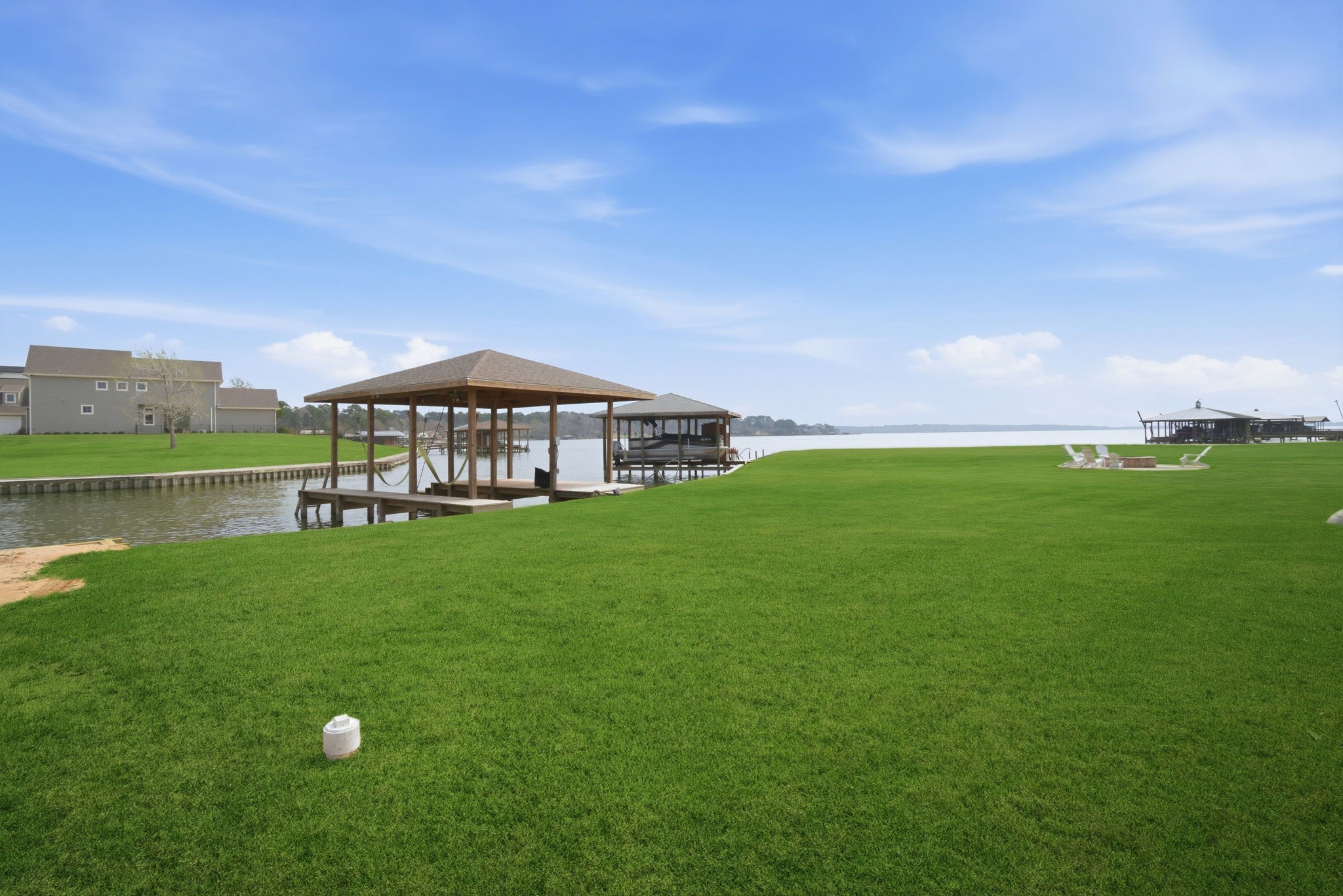255 Peninsula Drive Livingston, TX 77351 - Photo 45 of 50 Protected water. Beautiful view. Steel bulkhead. 10’ x 26’ boathouse and slip with electronic lift attached to a shaded and roofed deck with a kayak launch pad.