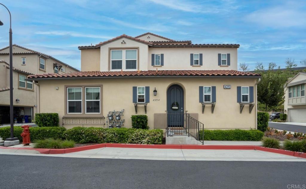 4315 Star Path Way, Unit 4 Oceanside, CA 92056 - Photo 2 of 40 a front view of a house with a garden