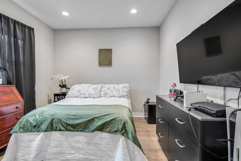 4315 Star Path Way, Unit 4 Oceanside, CA 92056 - Photo 23 of 40 a bedroom with a bed and a flat screen tv