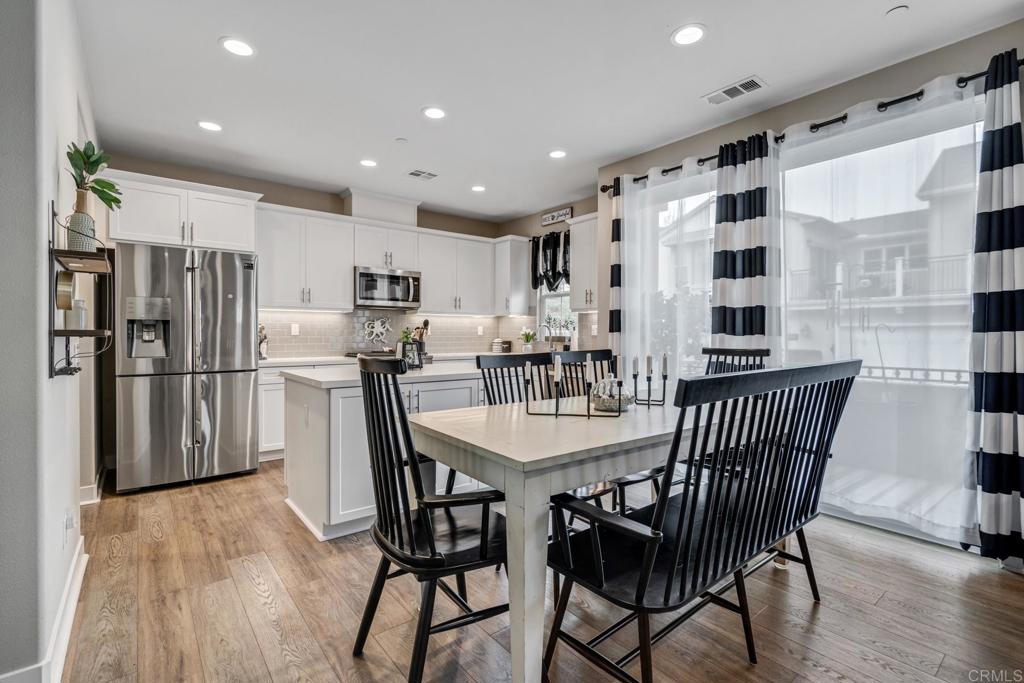4315 Star Path Way, Unit 4 Oceanside, CA 92056 - Photo 25 of 40 a view of kitchen with stainless steel appliances refrigerator dining table and chairs