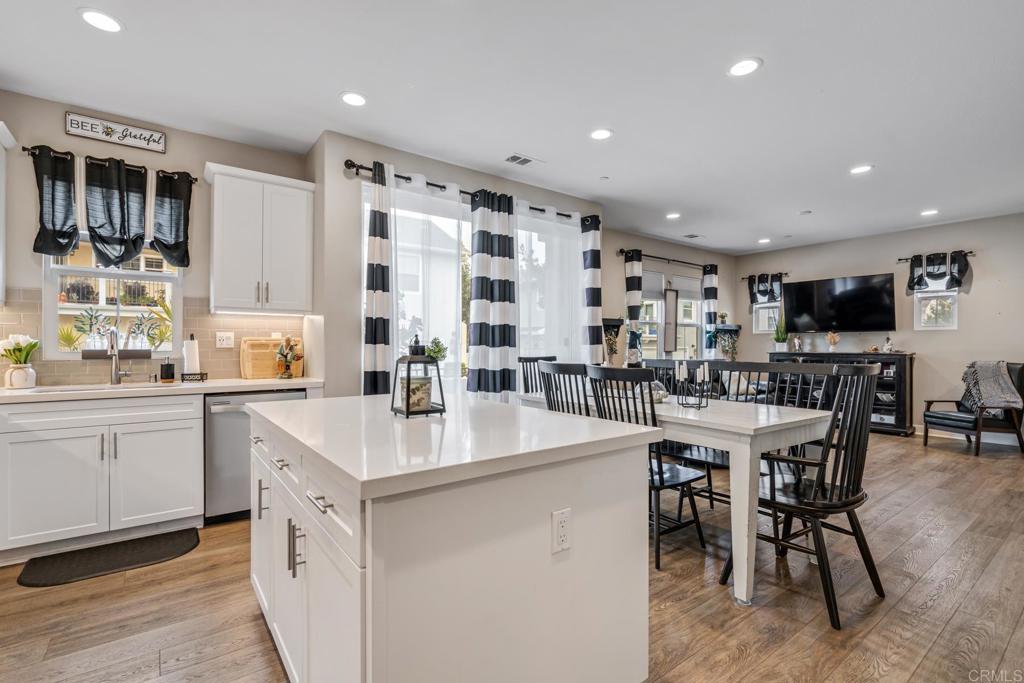 4315 Star Path Way, Unit 4 Oceanside, CA 92056 - Photo 29 of 40 a kitchen with stainless steel appliances kitchen island granite countertop a sink and cabinets