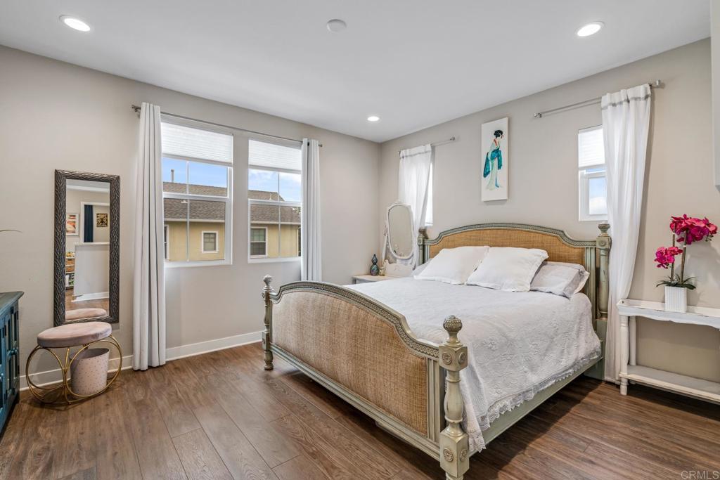 4315 Star Path Way, Unit 4 Oceanside, CA 92056 - Photo 8 of 40 a bedroom with a bed and wooden floor