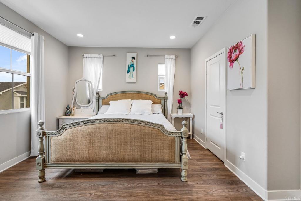 4315 Star Path Way, Unit 4 Oceanside, CA 92056 - Photo 9 of 40 a bedroom with a bed and a potted plant