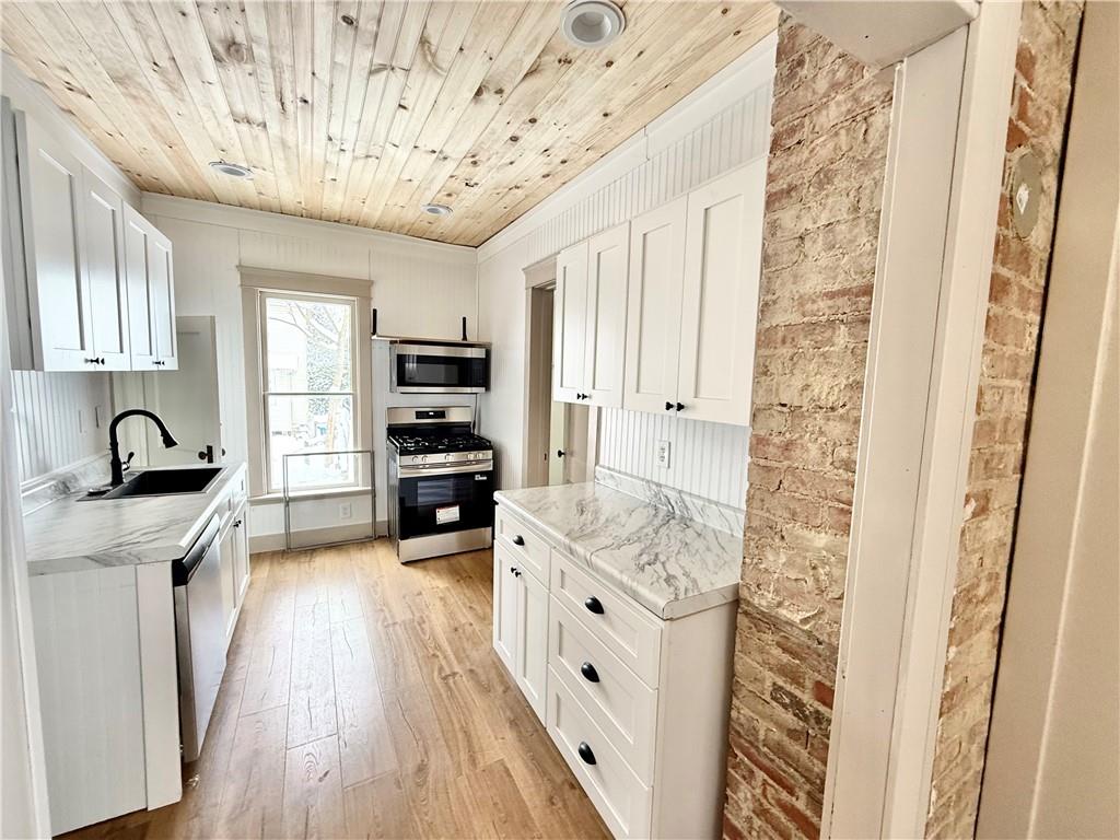 657 North Street Meadville, PA 16335 - Photo 12 of 21 a kitchen with stainless steel appliances granite countertop a lot of counter space and wooden floors