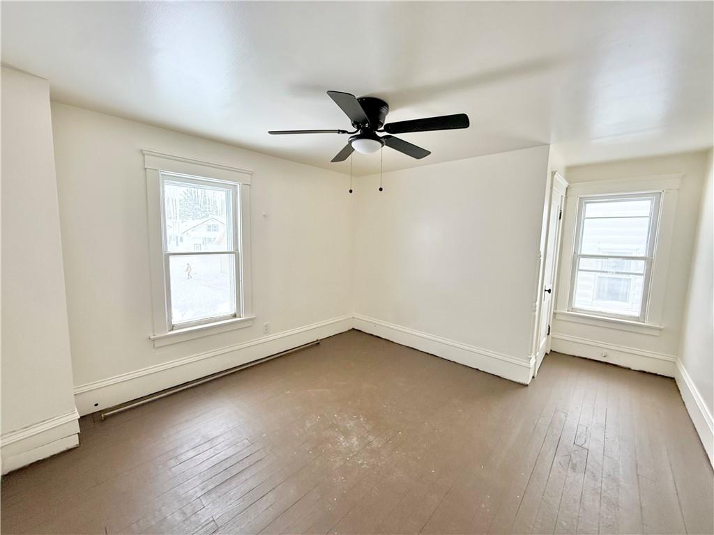 657 North Street Meadville, PA 16335 - Photo 16 of 21 an empty room with wooden floor ceiling fan and windows