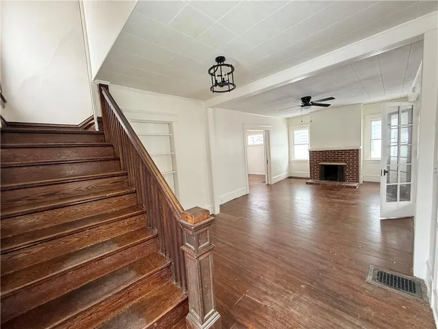 a view of entryway and hall with wooden floor
