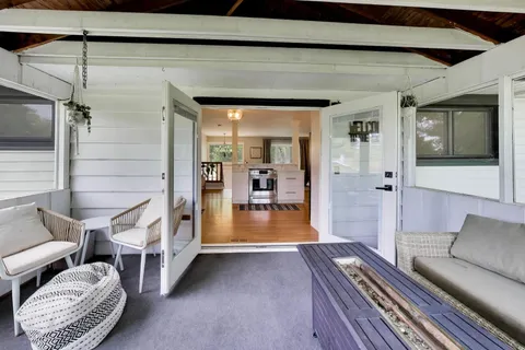 a view of a hallway with couch and wooden floor