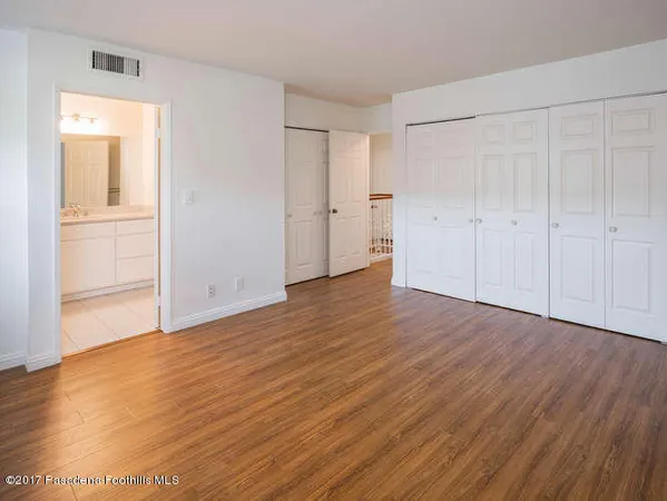 a view of an empty room and wooden floor