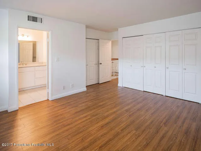 a view of an empty room and wooden floor