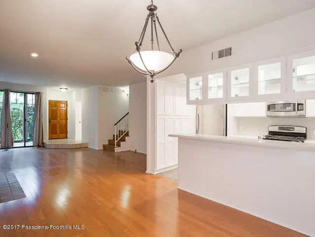 a view of a kitchen with a sink and a chandelier