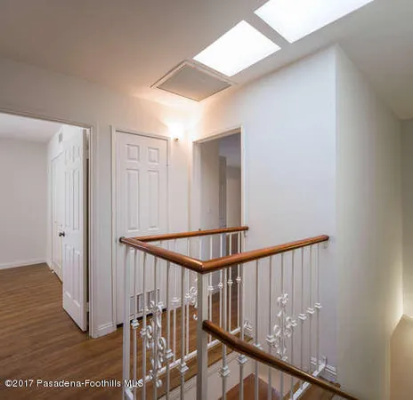 a view of staircase with railing and a rug