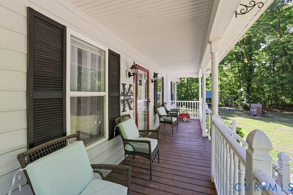 5307 St Pauls Church Road Goochland, VA 23063 - Photo 7 of 44 a view of a patio with couches dining table and chairs with wooden floor and fence