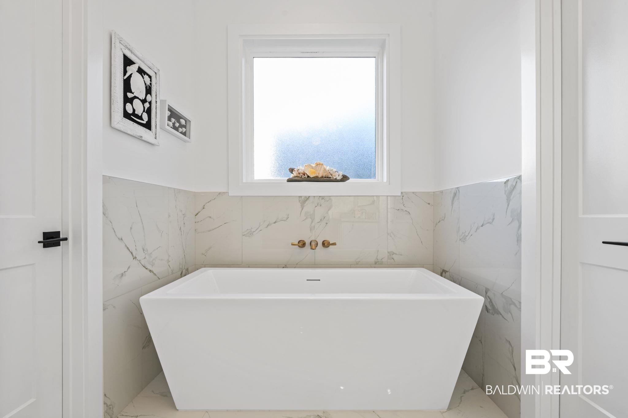 30313 River Road Orange Beach, AL 36561 - Photo 26 of 50 Full bath featuring marble tiled flooring, a soaking tub, wainscoting, and tile walls