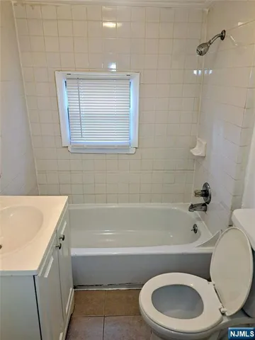 a bathroom with a toilet a sink and bathtub