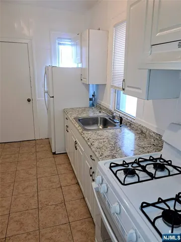 a kitchen with a sink stove and refrigerator