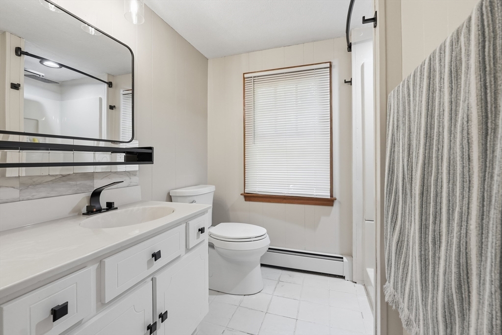 28 Spring Road Westborough, MA 01581 - Photo 22 of 42 a bathroom with a sink a toilet and mirror
