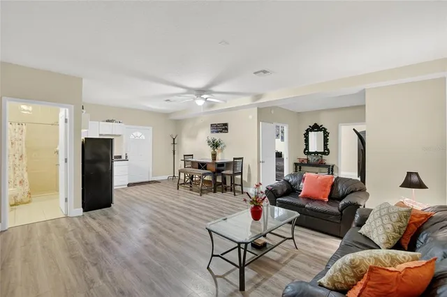 a living room with furniture and wooden floor