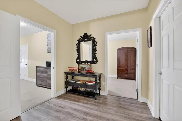 a view of room with furniture and wooden floor