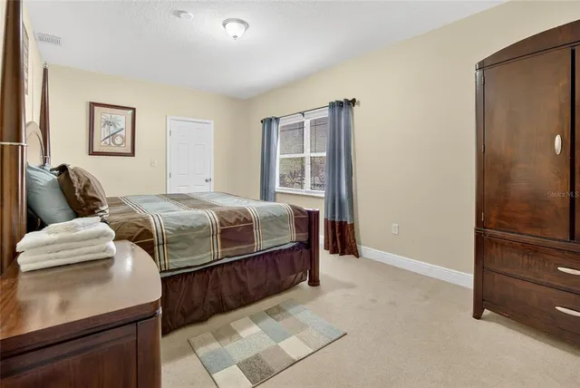 a bedroom with a bed and a dresser