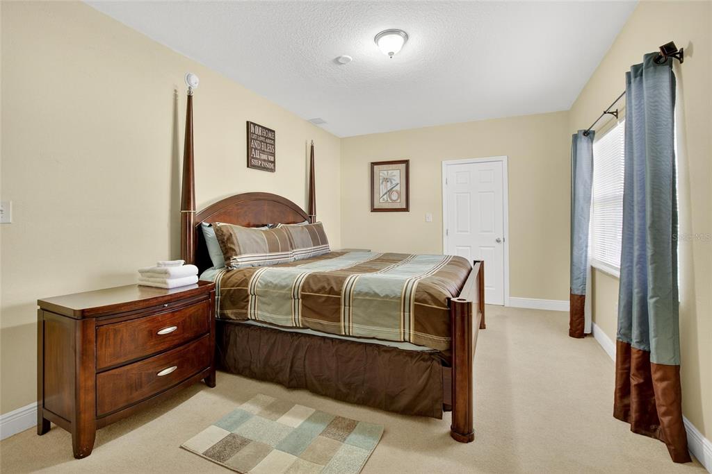 4639 Birdsong Boulevard, Unit 2 Lutz, FL 33559 - Photo 16 of 25 a bedroom with a bed and a window