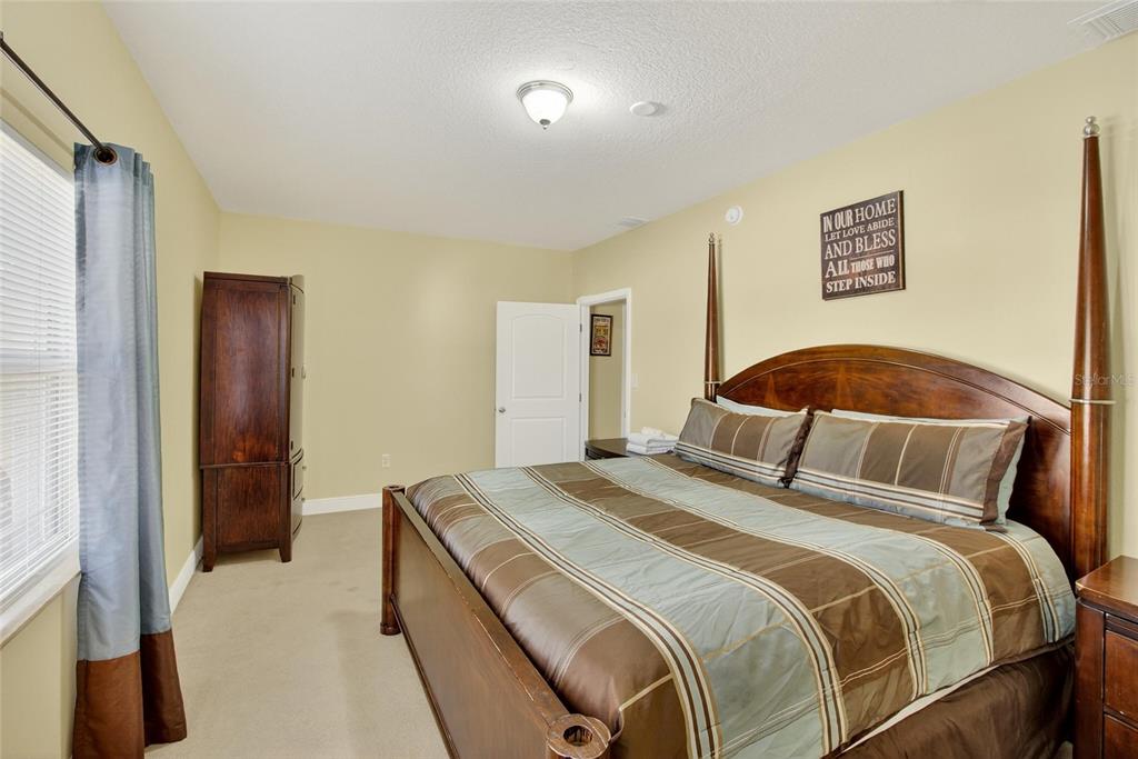 4639 Birdsong Boulevard, Unit 2 Lutz, FL 33559 - Photo 17 of 25 a bedroom with a bed and a walk in closet